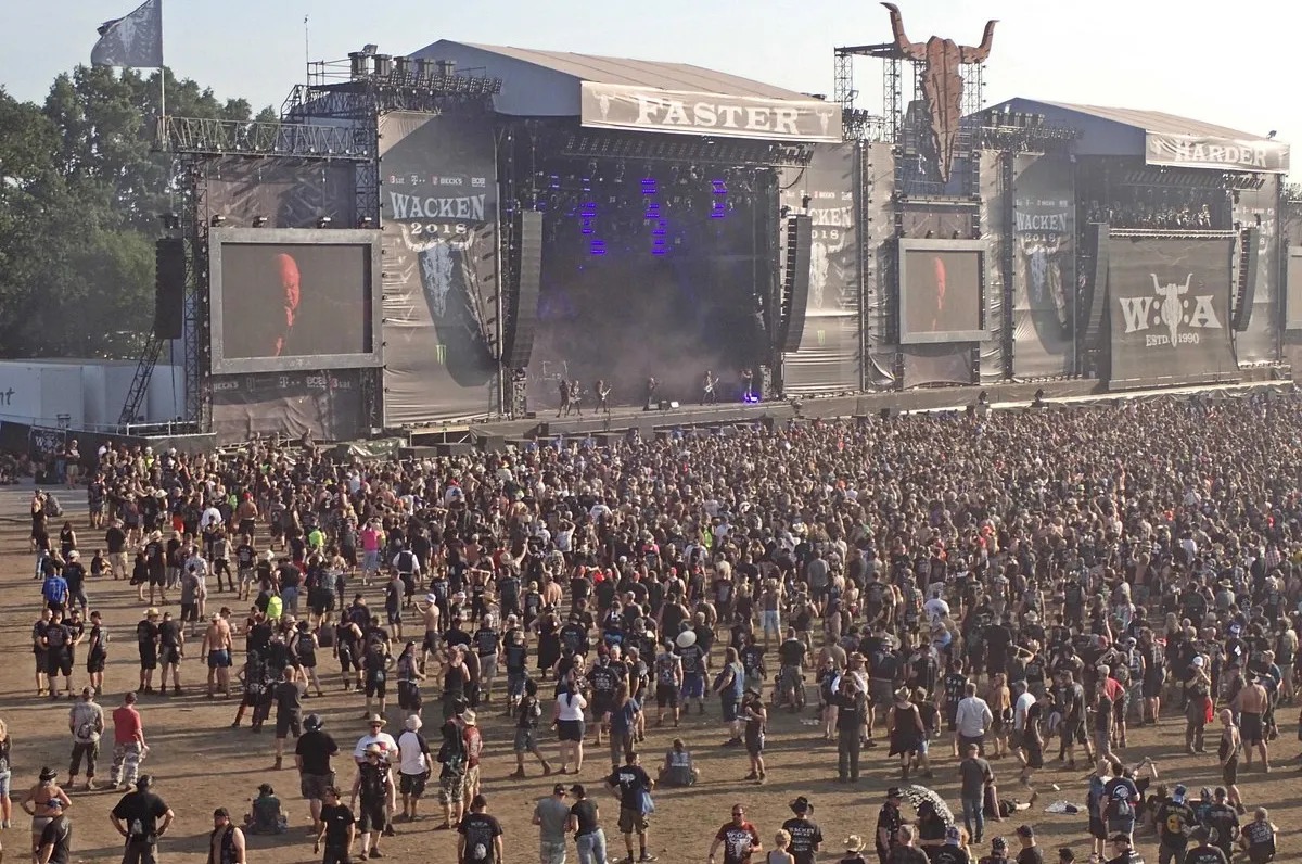 Daytime drone point of view of wacken stage and crowd.